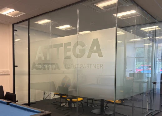 an internal frosted-glass office with the word Attega etched into it